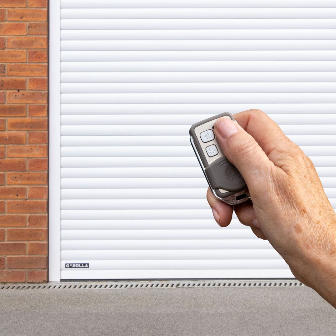 Homeowner opening Garolla roller garage door with remote