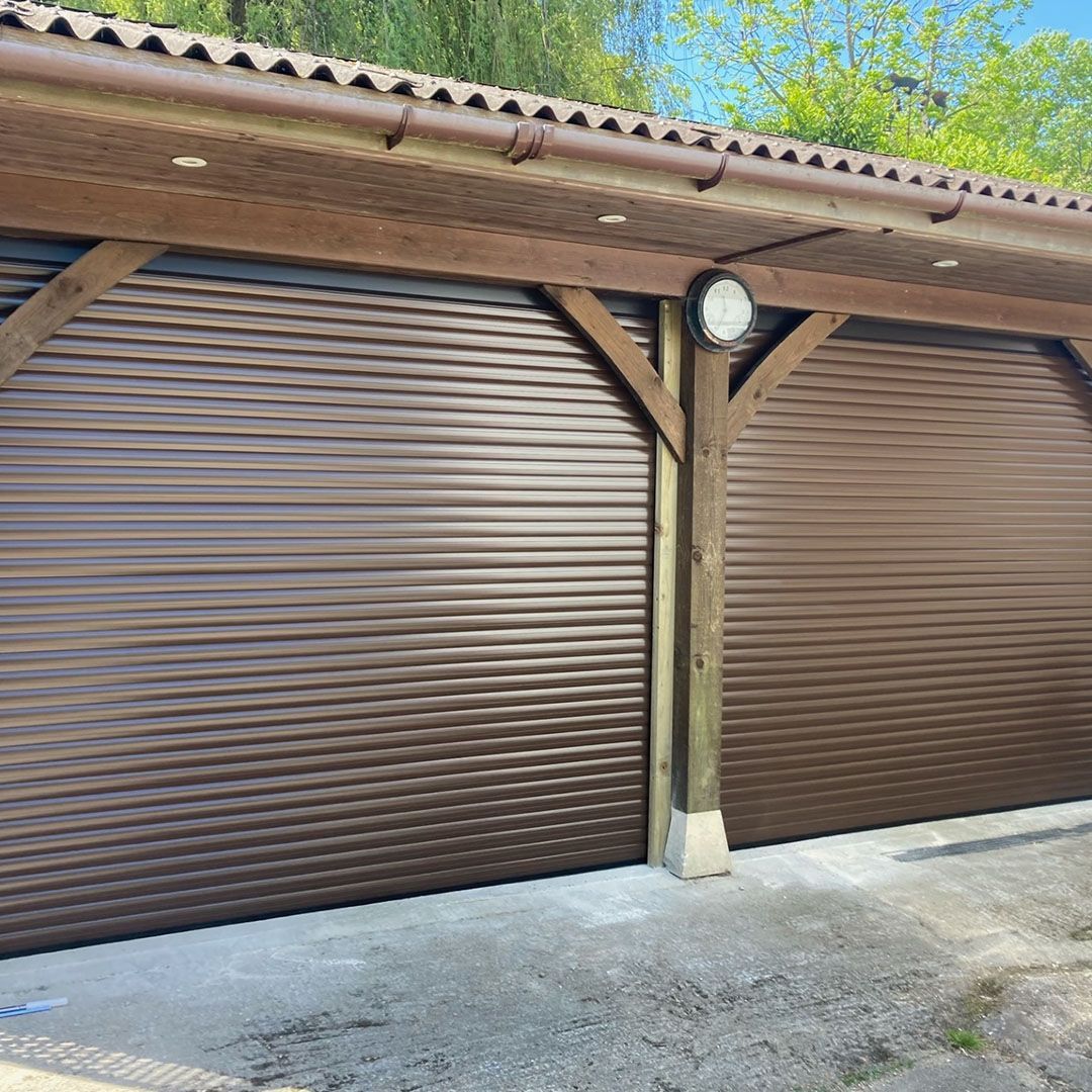 Garolla Transform 55mm double brown electric roller garage doors on wood frame garage