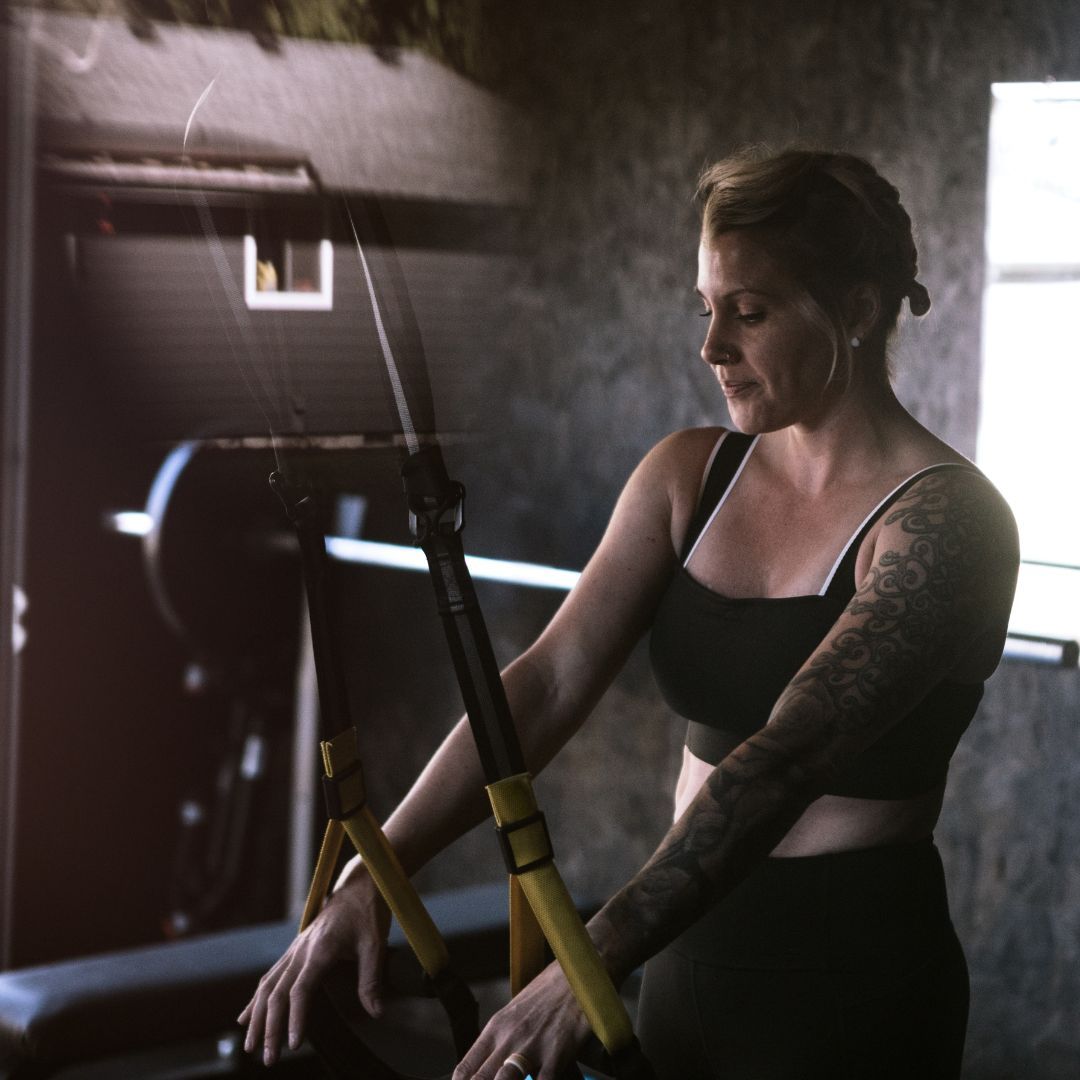 Woman working out in her home gym in garage