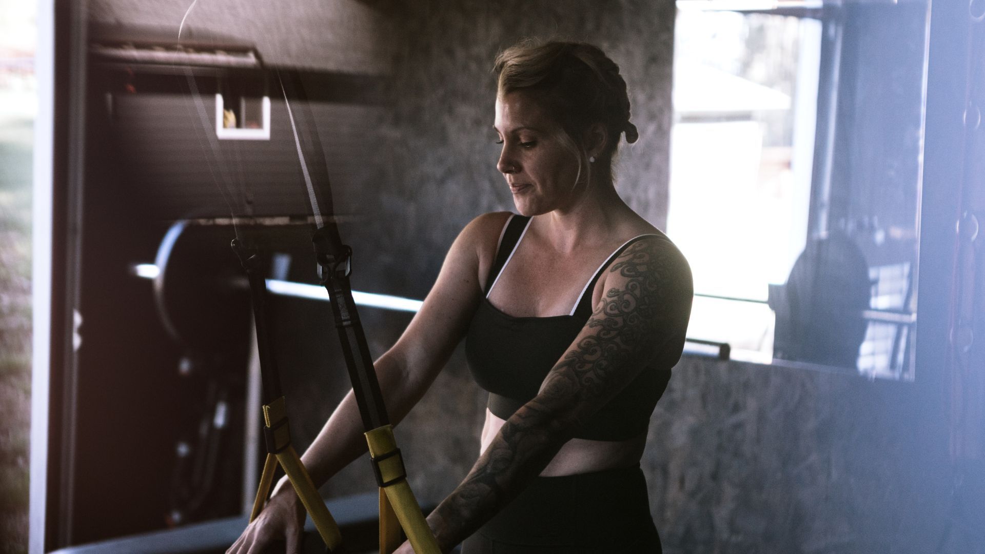 Woman working out in her home gym in garage