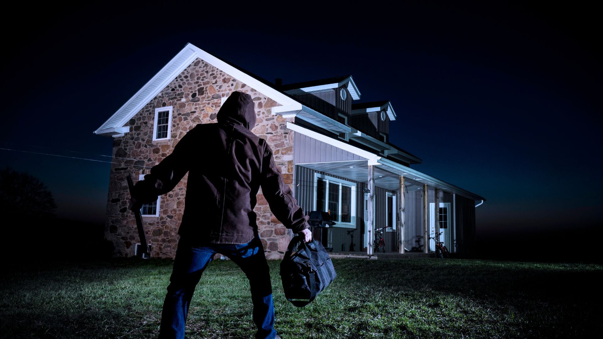 Burglar approaches house to test garage door security