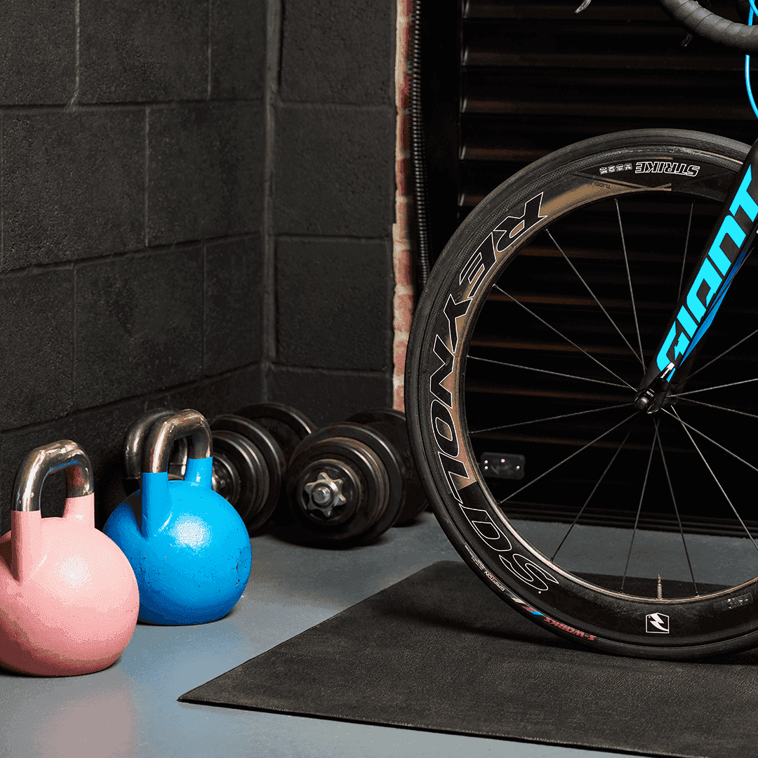 Bike and weights in front of Garolla Titan electric roller garage door