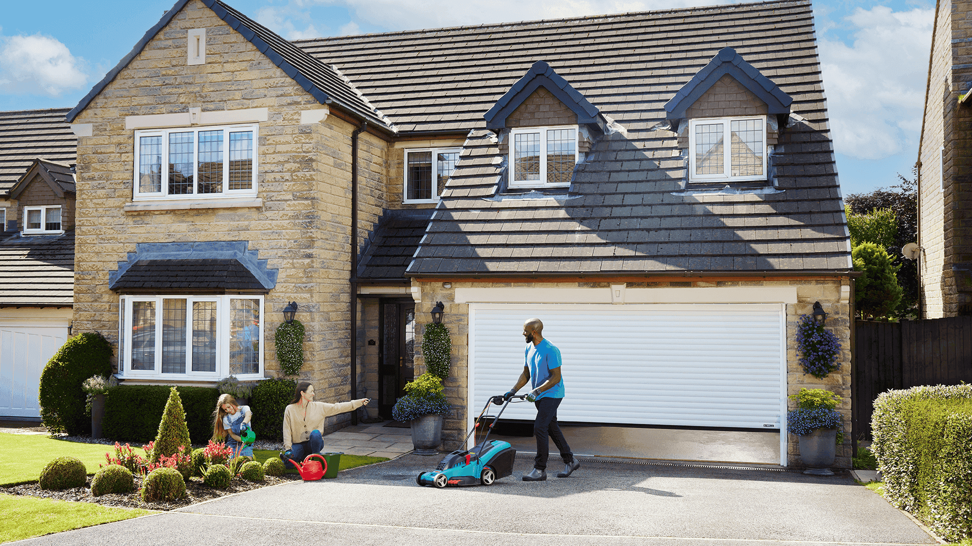 Garolla Titan 77mm garage door with gardener pushing a lawnmower