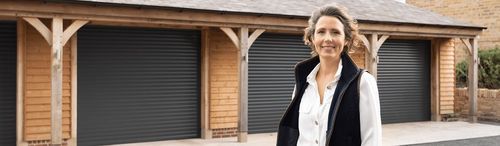 A Garolla happy customer in front of garage doors